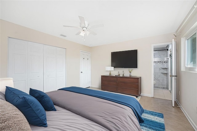 tiled bedroom featuring connected bathroom, a closet, and ceiling fan