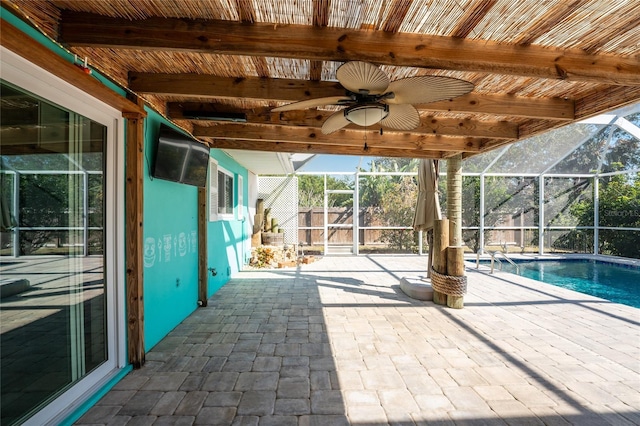 view of pool featuring ceiling fan, a patio, and glass enclosure