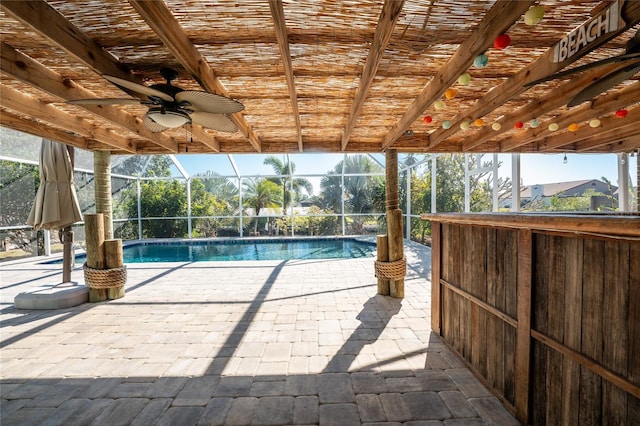 view of pool with ceiling fan, a lanai, and a patio area