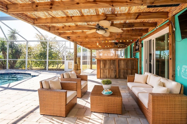 view of patio / terrace featuring an outdoor living space, ceiling fan, and glass enclosure