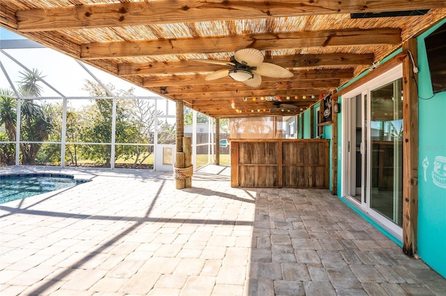 view of patio featuring ceiling fan and glass enclosure