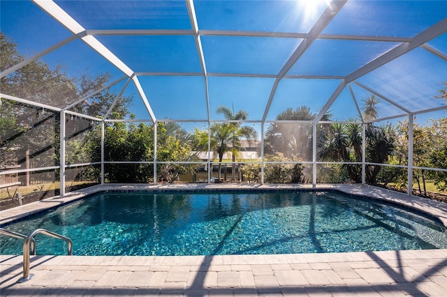 view of swimming pool with glass enclosure