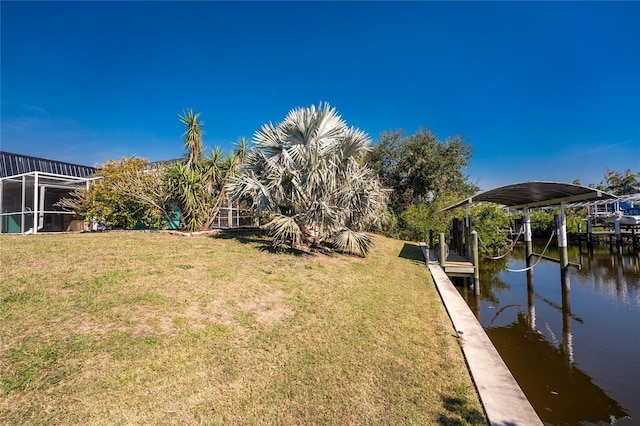 dock area featuring a water view and a yard