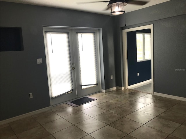 entryway with tile patterned floors, ceiling fan, and french doors