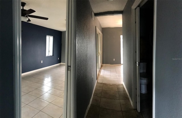 hall featuring light tile patterned floors