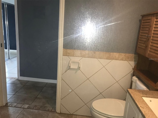 bathroom featuring vanity, tile patterned floors, and toilet