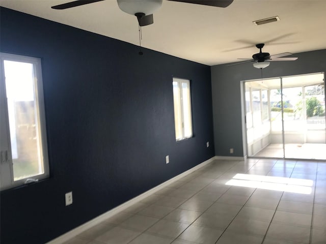 tiled empty room with ceiling fan