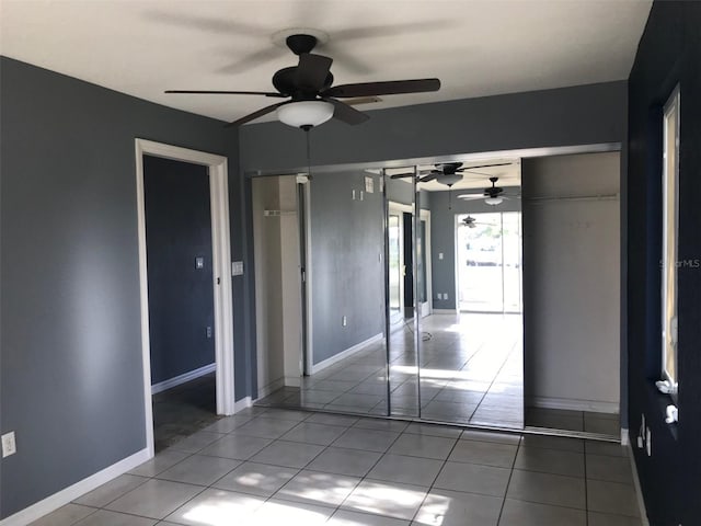 unfurnished bedroom featuring light tile patterned flooring and ceiling fan