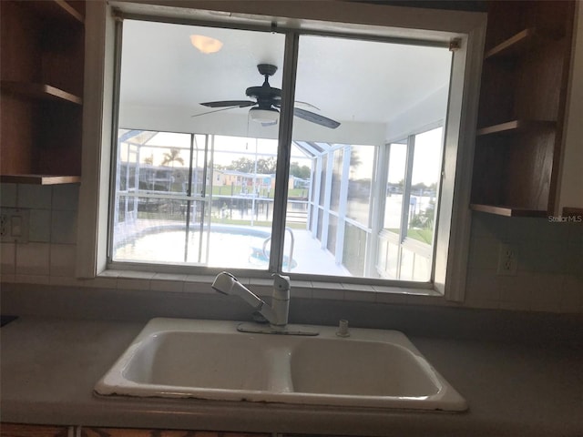 kitchen with sink, ceiling fan, and a water view