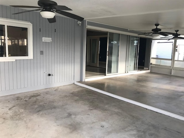 unfurnished sunroom with ceiling fan