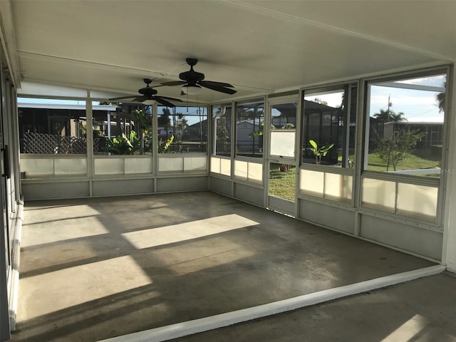 unfurnished sunroom with ceiling fan