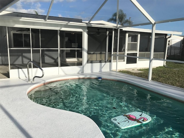 view of pool with ceiling fan and a sunroom