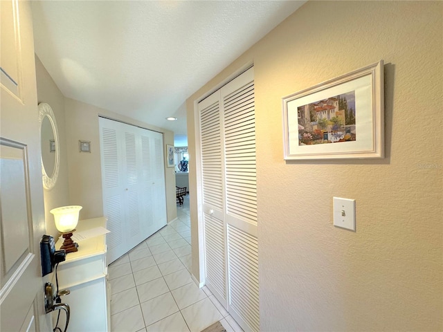 hallway featuring light tile patterned floors