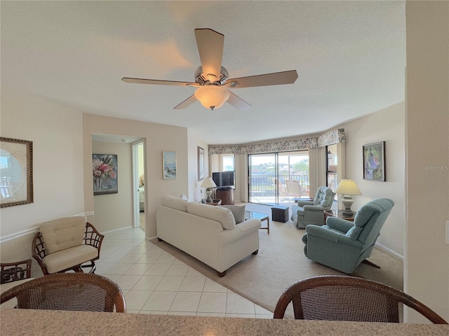 tiled living room featuring ceiling fan