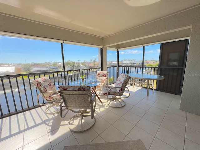 sunroom / solarium with a water view