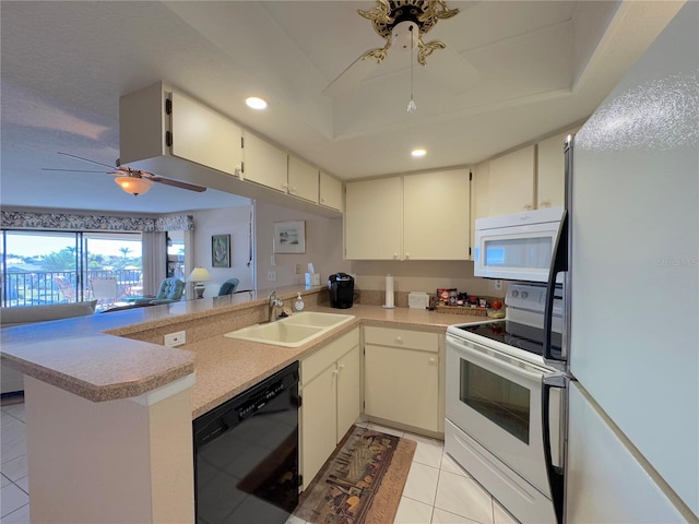 kitchen with sink, white appliances, ceiling fan, cream cabinets, and kitchen peninsula