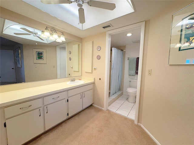 bathroom with walk in shower, ceiling fan, vanity, and toilet