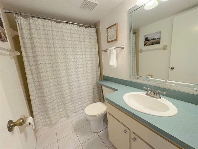 bathroom featuring vanity, toilet, tile patterned flooring, and a textured ceiling