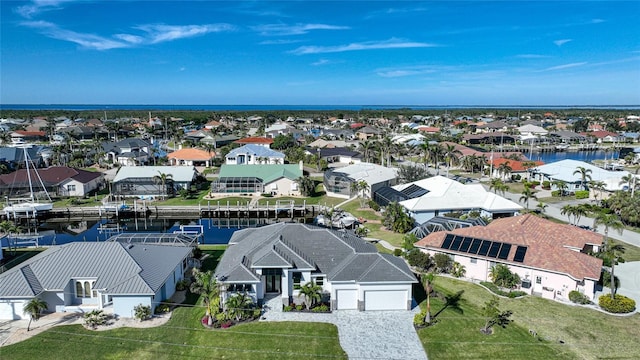 drone / aerial view with a water view and a residential view