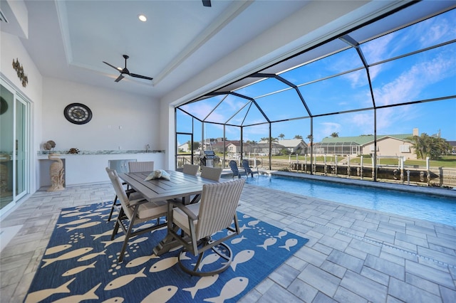 exterior space with ceiling fan and glass enclosure