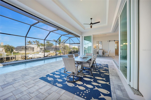 view of patio / terrace with ceiling fan and glass enclosure