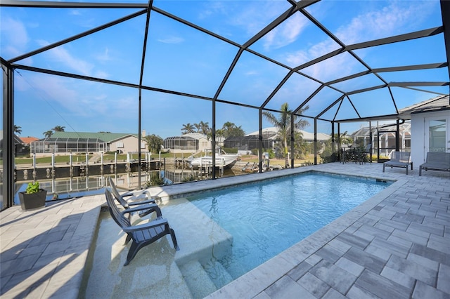 view of pool with a water view, a patio, and glass enclosure