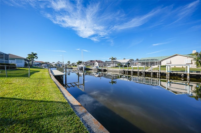 dock area with a yard and a water view