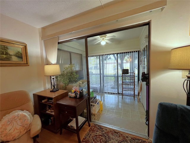 doorway to outside with a textured ceiling and ceiling fan