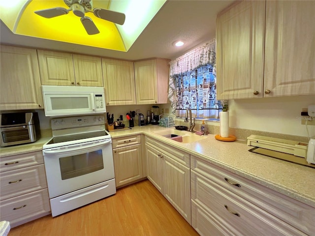 kitchen with sink, white appliances, ceiling fan, light hardwood / wood-style floors, and light brown cabinets