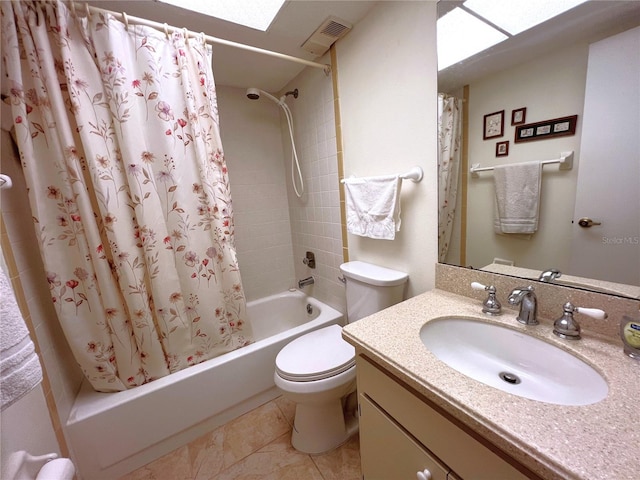 full bathroom featuring vanity, a skylight, shower / bath combination with curtain, and toilet