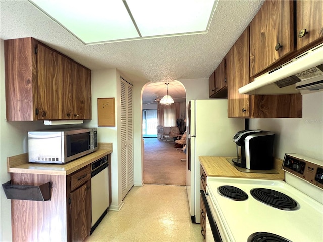 kitchen with pendant lighting, stainless steel appliances, and a textured ceiling