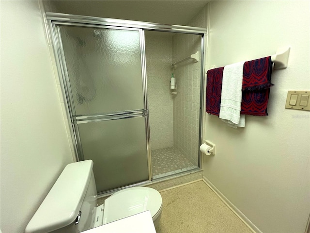 bathroom featuring walk in shower and toilet