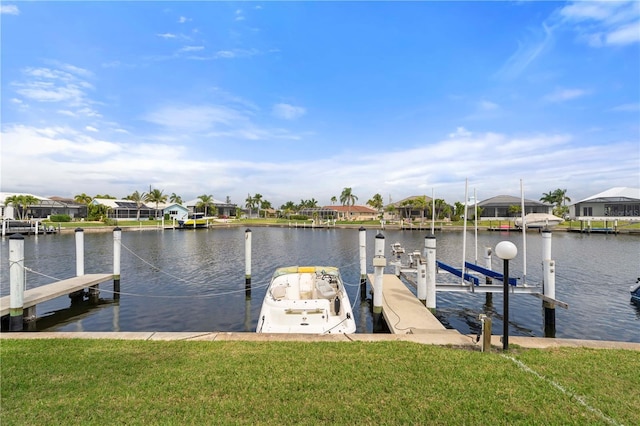 view of dock with a water view and a lawn