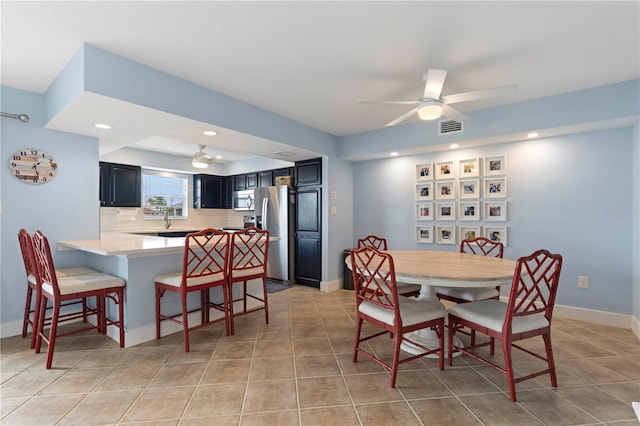 dining area with light tile patterned floors and ceiling fan