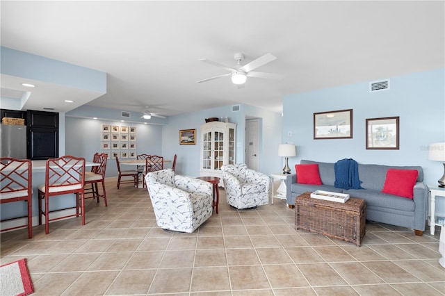 tiled living room featuring ceiling fan