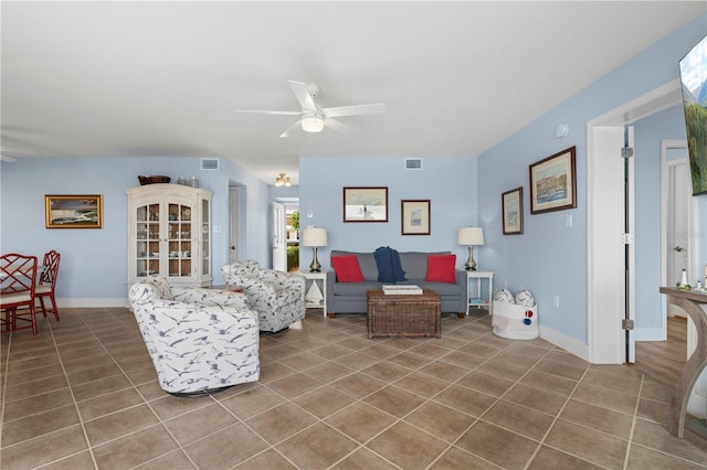 living room featuring tile patterned flooring and ceiling fan