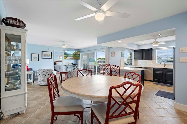 dining room with sink, light tile patterned floors, and ceiling fan