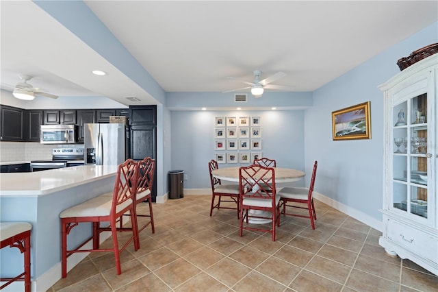 dining space featuring ceiling fan and light tile patterned floors