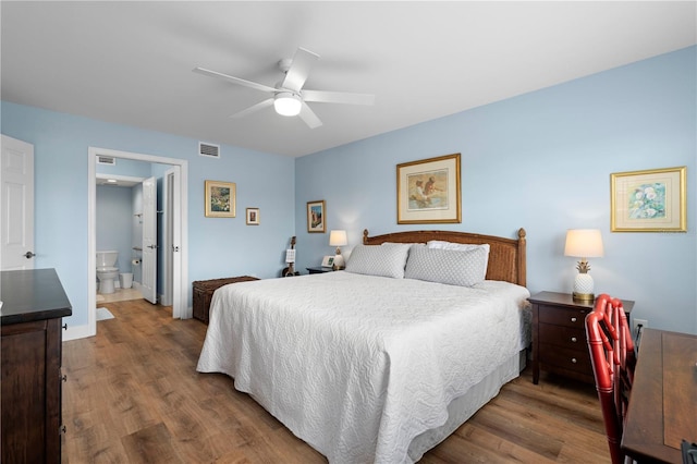 bedroom featuring ceiling fan, wood-type flooring, and ensuite bath