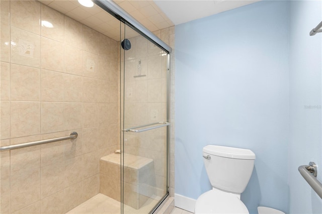 bathroom with a shower with door and toilet