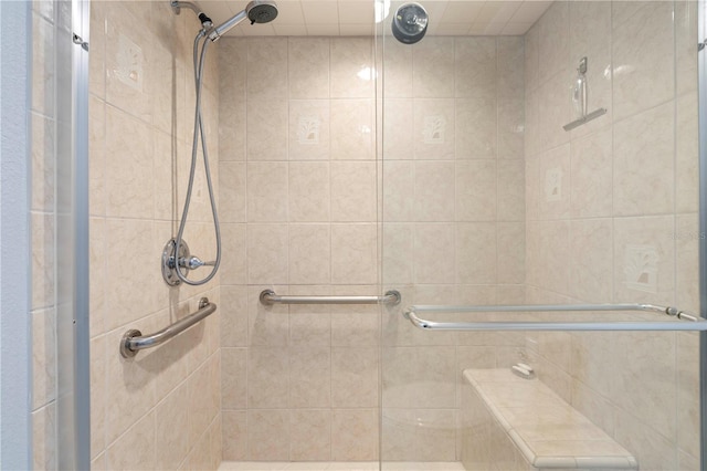 bathroom featuring a shower with shower door