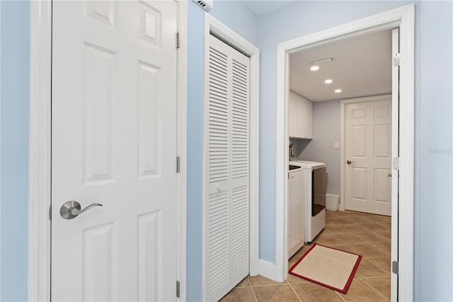 laundry room with cabinets, light tile patterned floors, and independent washer and dryer