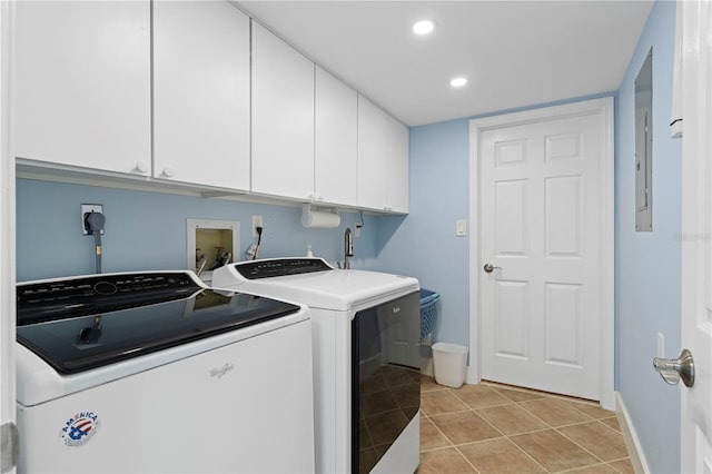 laundry room featuring light tile patterned flooring, cabinets, and separate washer and dryer