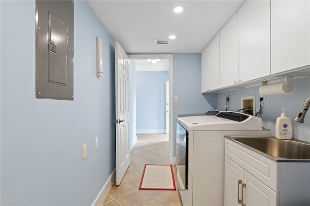 laundry room with sink, washing machine and dryer, cabinets, electric panel, and light tile patterned flooring