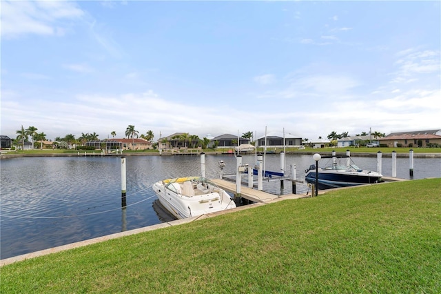 dock area featuring a water view and a lawn