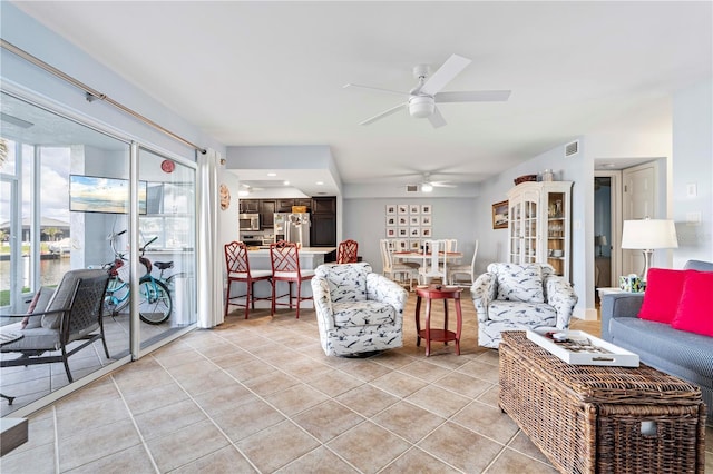 living room featuring light tile patterned flooring and ceiling fan