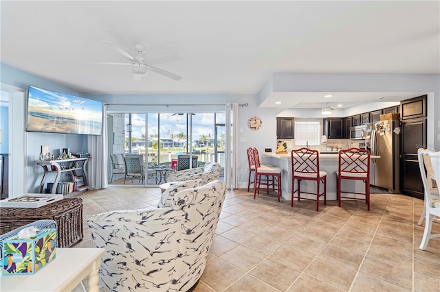 living room featuring light tile patterned flooring and ceiling fan