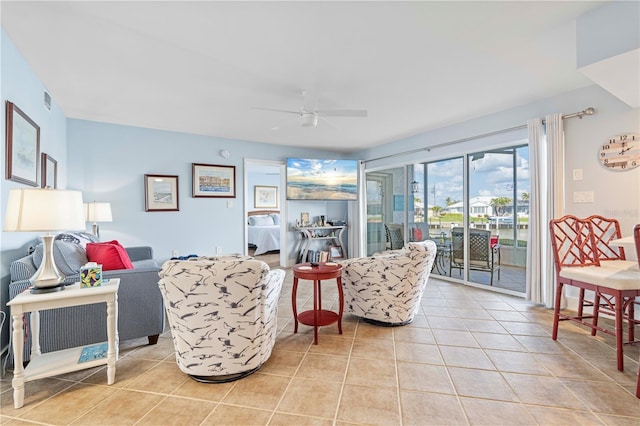 living room featuring light tile patterned flooring and ceiling fan