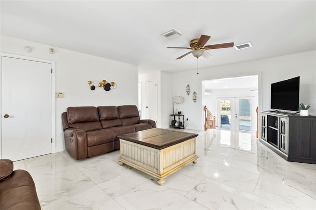 living room featuring french doors and ceiling fan