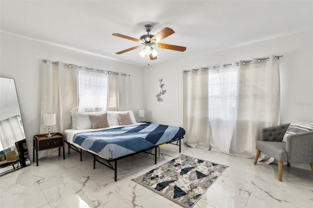 bedroom featuring multiple windows and ceiling fan